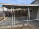 Covered patio area with seating and chain link fence at 1920 Walnut Ave, Las Vegas, NV 89101