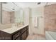 Bathroom with tub and shower, vanity, and mirror at 205 E Harmon Ave # 220, Las Vegas, NV 89169