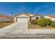 One-story house with attached garage, landscaping, and a well-maintained front yard at 5717 Wizard Wand St, North Las Vegas, NV 89031