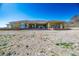 House exterior showcasing large windows and desert landscaping at 4751 W Adkisson St, Pahrump, NV 89060