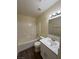 Clean bathroom with a shower/tub combo, white vanity, and LVP flooring at 8009 Draco Cir # 201, Las Vegas, NV 89128