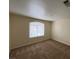 Bright bedroom with neutral walls, carpet, and window coverings at 8009 Draco Cir # 201, Las Vegas, NV 89128