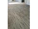 Grey wood-look vinyl flooring throughout the home at 664 Sky Rd, Indian Springs, NV 89018