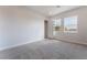 Bright bedroom with grey carpet and access to a closet at 6235 Fire Lake Ct, Las Vegas, NV 89149