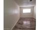 Bright bedroom with wood-look floors and large window at 5126 Golden Ln # A, Las Vegas, NV 89119