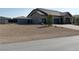 Single-story home with three-car garage and desert landscaping at 4841 E Graystone Dr, Pahrump, NV 89061