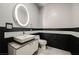 Modern bathroom with a white sink, black tile, and a large mirror at 900 Las Vegas Blvd # 1507, Las Vegas, NV 89101