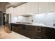 Modern kitchen with dark wood cabinetry and stainless steel appliances at 900 Las Vegas Blvd # 1507, Las Vegas, NV 89101