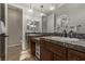 Elegant bathroom with double vanity, dark wood cabinets, and a marble countertop at 1202 Calcione Dr, Henderson, NV 89011