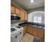 Kitchen features granite counters and light wood cabinets at 1209 Equator Ave, North Las Vegas, NV 89032