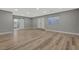 Spacious basement room with light wood-look flooring and a sliding barn door at 909 Rhyolite Ter, Henderson, NV 89011