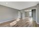 Spacious bedroom with wood-look flooring and a closet with mirrored sliding doors at 909 Rhyolite Ter, Henderson, NV 89011