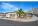 View of the front of the house with palm trees, landscaping, and a street view at 909 Rhyolite Ter, Henderson, NV 89011