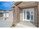 Front entryway with glass door, stone accents, and a covered porch at 909 Rhyolite Ter, Henderson, NV 89011