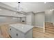 View of the kitchen island, staircase, and adjacent living area at 909 Rhyolite Ter, Henderson, NV 89011