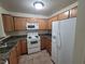 Well-equipped kitchen with granite counters and white appliances at 7730 Secret Shore Dr # 207, Las Vegas, NV 89128