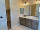 Double vanity bathroom with modern fixtures and large mirror at 9166 Chandler Bloom Ct, Las Vegas, NV 89139