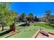 Expansive backyard with a putting green, pool, and outdoor seating at 8275 W Craig Rd, Las Vegas, NV 89129