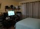 Bedroom with a bed, desk, and window with curtains at 5068 S Rainbow Blvd # 105, Las Vegas, NV 89118