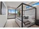 Modern bedroom featuring a canopy bed, large windows, and soft carpeting at 32 Rainbow Point Pl, Henderson, NV 89011