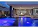 Illuminated pool and spa with fire feature at night at 32 Rainbow Point Pl, Henderson, NV 89011