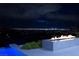 Night view of fire pit and pool with city lights in the background at 643 Cityview Ridge Dr, Henderson, NV 89012