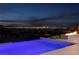 Night view of a luxurious pool with city lights in the background at 643 Cityview Ridge Dr, Henderson, NV 89012