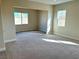 Bright bedroom with carpeted floors and two windows offering natural light at 10096 Goff Grove Ct, Las Vegas, NV 89183