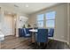 Charming dining area with a round table and four blue chairs, virtually staged at 642 Angel Aura St, Las Vegas, NV 89138