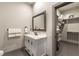 Clean bathroom with white vanity, marble countertop, and walk-in closet at 7880 Dana Point Ct, Las Vegas, NV 89117