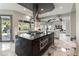 Stylish kitchen with a dark center island, white cabinetry, and stainless steel appliances at 7880 Dana Point Ct, Las Vegas, NV 89117