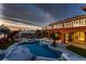 Relaxing pool area with patio, lounge chairs, and dinosaur statues at 420 Dakar St, Henderson, NV 89015