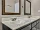 Double vanity bathroom with dark wood cabinets and light countertops at 5410 S Mojave Rd, Las Vegas, NV 89120