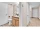 Simple, clean bathroom with wood vanity and granite countertop at 3597 Arville St # 201C, Las Vegas, NV 89103