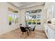 Bright breakfast nook with glass table and four black chairs, overlooking the backyard at 10309 Saugus Dr, Las Vegas, NV 89134