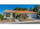 Single story home with terracotta tile roof and landscaped yard at 10309 Saugus Dr, Las Vegas, NV 89134