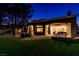 Night view of home's exterior, highlighting backyard patio and landscaping at 10309 Saugus Dr, Las Vegas, NV 89134