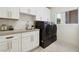 Laundry room with white cabinets, gray countertop, and washer and dryer at 10309 Saugus Dr, Las Vegas, NV 89134