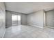 Living room with tile floors and access to a balcony at 5220 Mission Carmel Ln # 107, Las Vegas, NV 89107