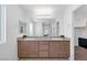 Dual vanity bathroom with granite countertops, mirrors, and ample lighting at 3929 E Weld Ave, Pahrump, NV 89061