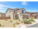 Front exterior of a two-story home with a two-car garage and desert landscaping at 3929 E Weld Ave, Pahrump, NV 89061