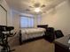 Bright bedroom with a queen-size bed, ceiling fan, and home office space at 457 E Merlayne Dr, Henderson, NV 89011