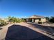 Large backyard with patio, landscaping, and partial home view at 457 E Merlayne Dr, Henderson, NV 89011