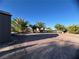 Landscaped backyard with a circular patio and storage shed at 457 E Merlayne Dr, Henderson, NV 89011