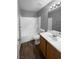 Clean bathroom with wood vanity and bathtub shower combo at 2958 Kensington St, Las Vegas, NV 89156