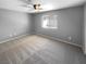 Well-lit bedroom with gray walls, ceiling fan, and window at 2958 Kensington St, Las Vegas, NV 89156