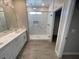 Bathroom with double vanity, large shower, and gray flooring at 220 Happy Canyon Rd, Pahrump, NV 89048