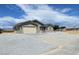 Newly built home showcasing a beige exterior and gravel driveway at 220 Happy Canyon Rd, Pahrump, NV 89048