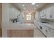 Kitchen with white cabinets, quartz countertops, and island at 2060 Crown View St, Henderson, NV 89052