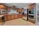 Kitchen boasts stainless steel appliances and rich wood cabinets at 6160 W Oquendo Rd, Las Vegas, NV 89118